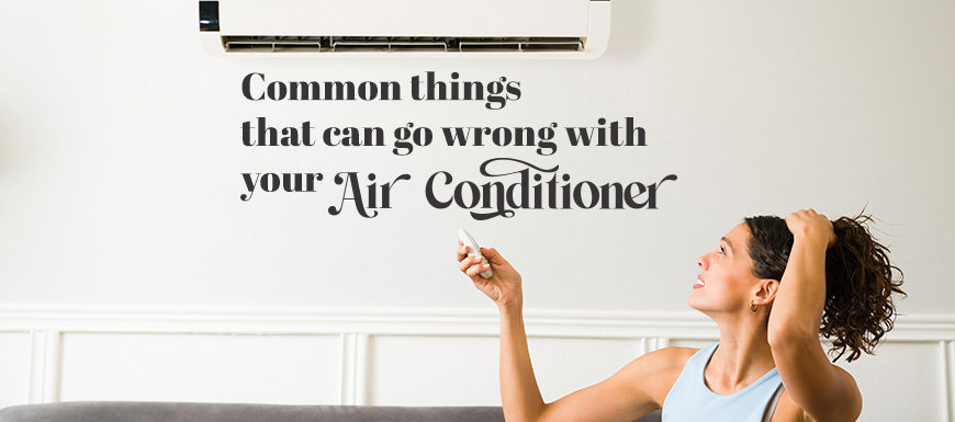 Woman pointing control at her AC unit